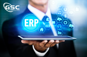 Businessperson holding a tablet with a glowing 'ERP' icon and digital, interconnected tech graphics.]